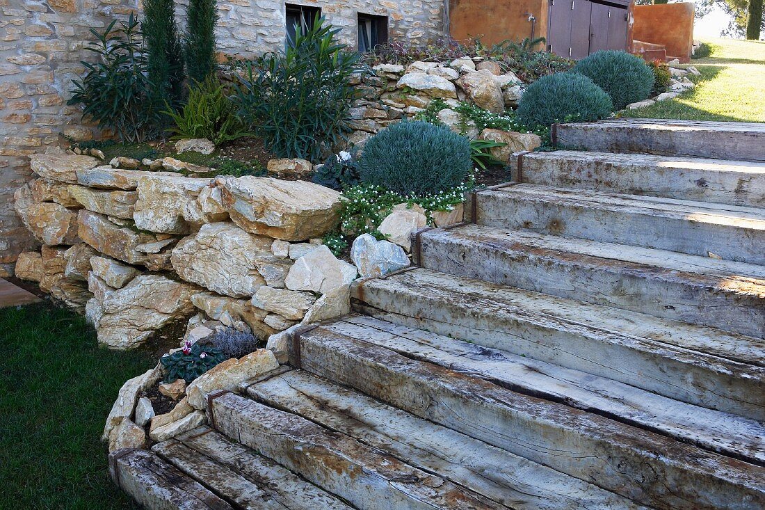 Stairs next to a natural stone raised planter