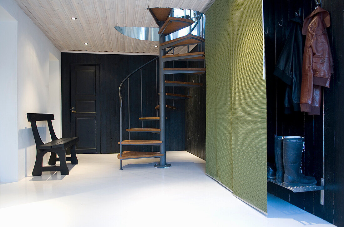 Entrance area with spiral staircase and wooden elements