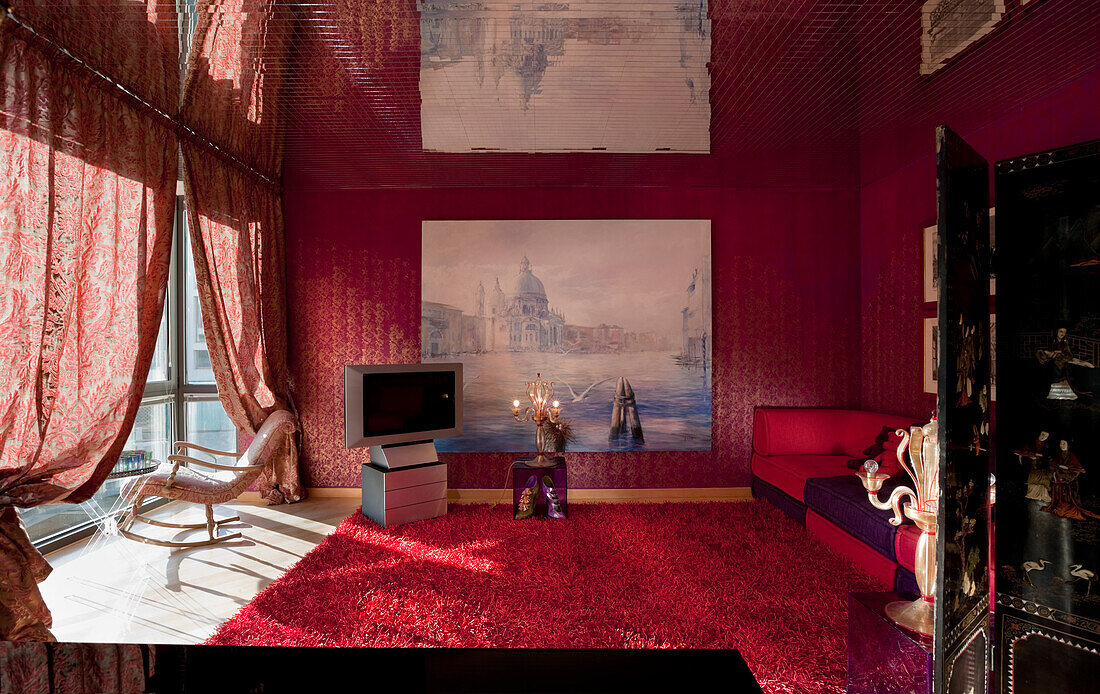 Opulent living room with red carpet and large painting of Venice