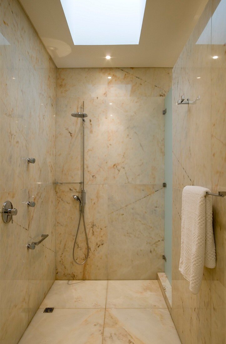 Shower room with marble tiling and skylight