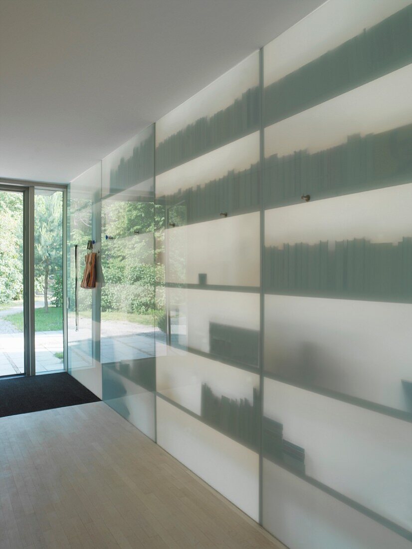 Room-height shelving with translucent glass front