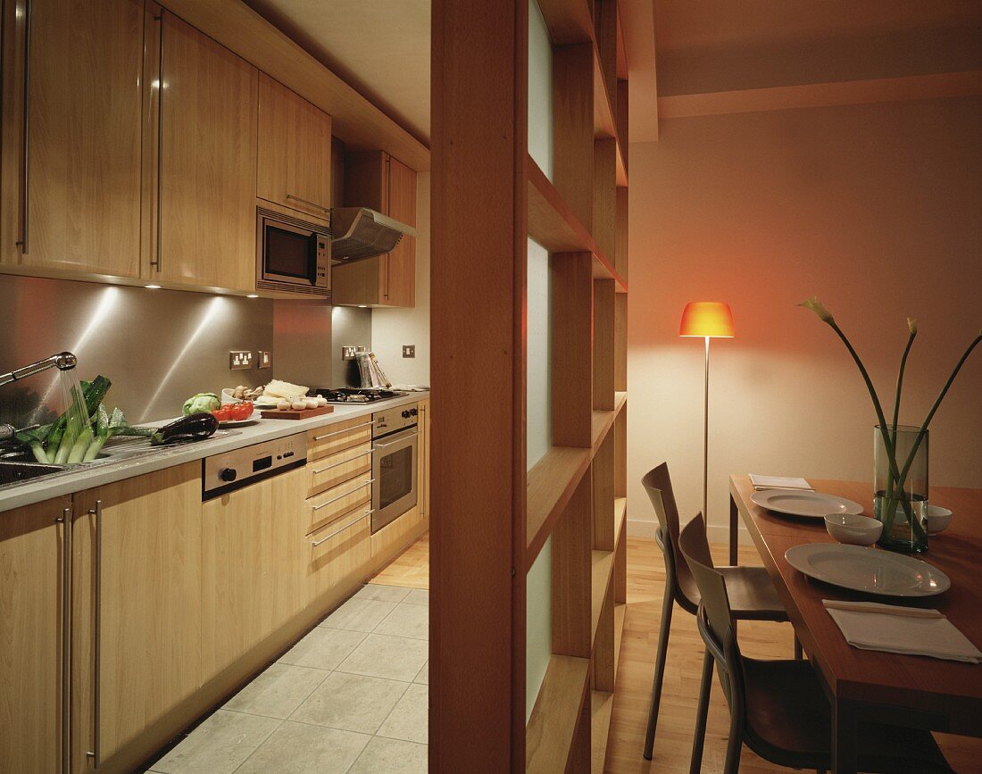 Kitchen and dining room separated by wood and glass partition