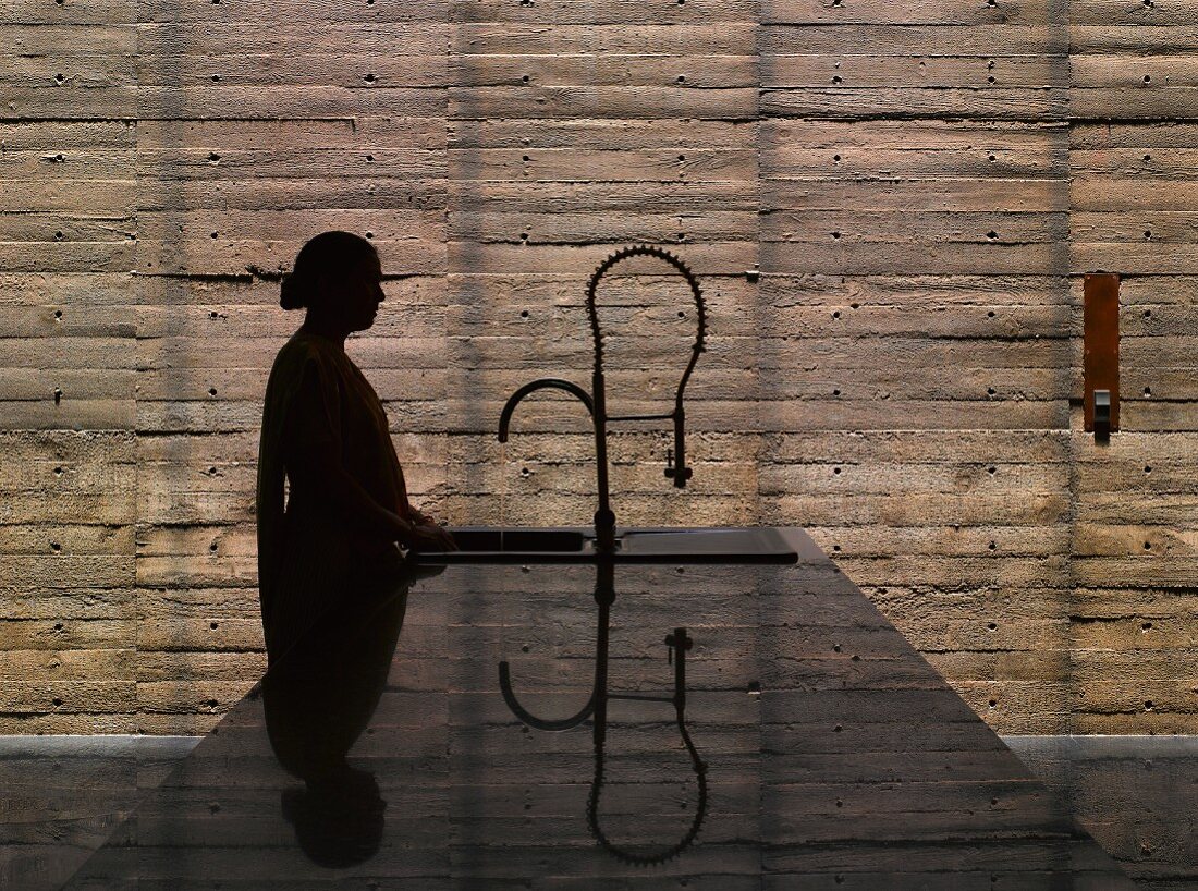 Woman standing at kitchen island sink