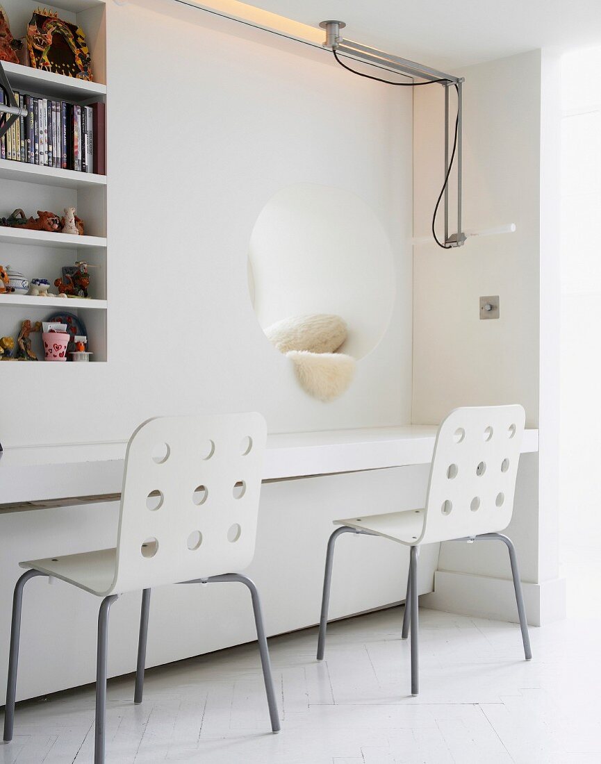 Chairs in front of built-in table top, niche and shelves