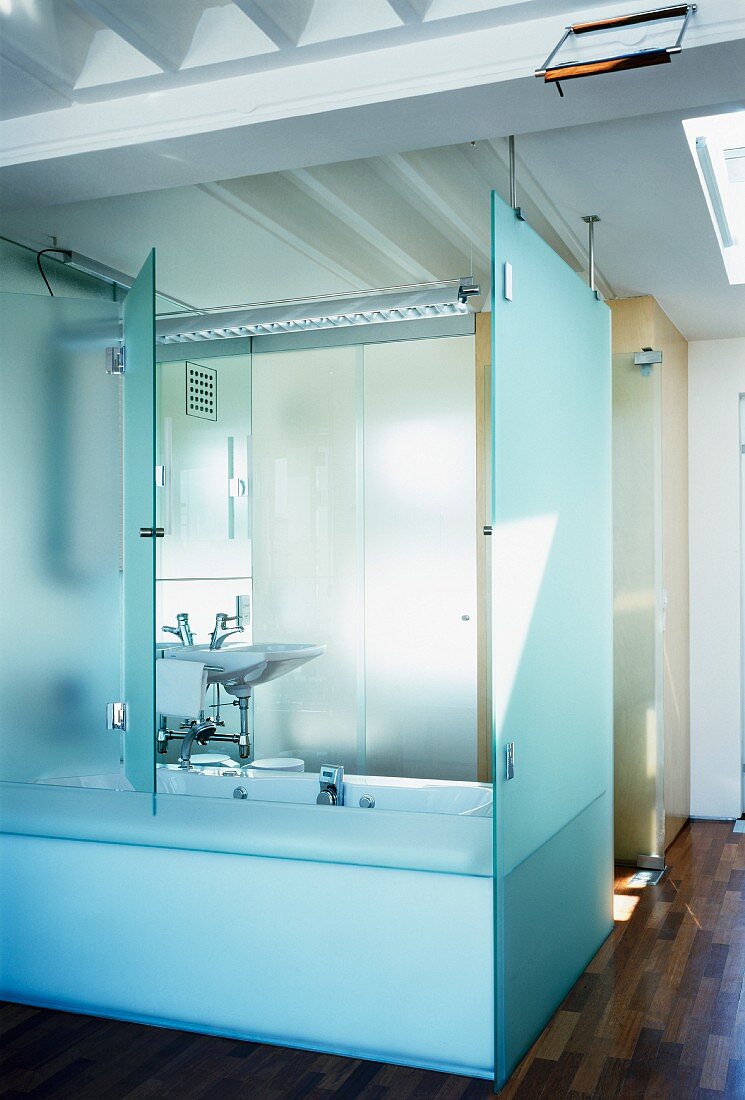 Bathroom with half-open, folding, glass bathtub partition