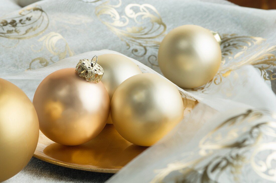 Gold Christmas tree baubles in a bowl