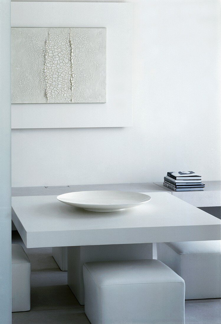 Minimalist dining table with white leather stools