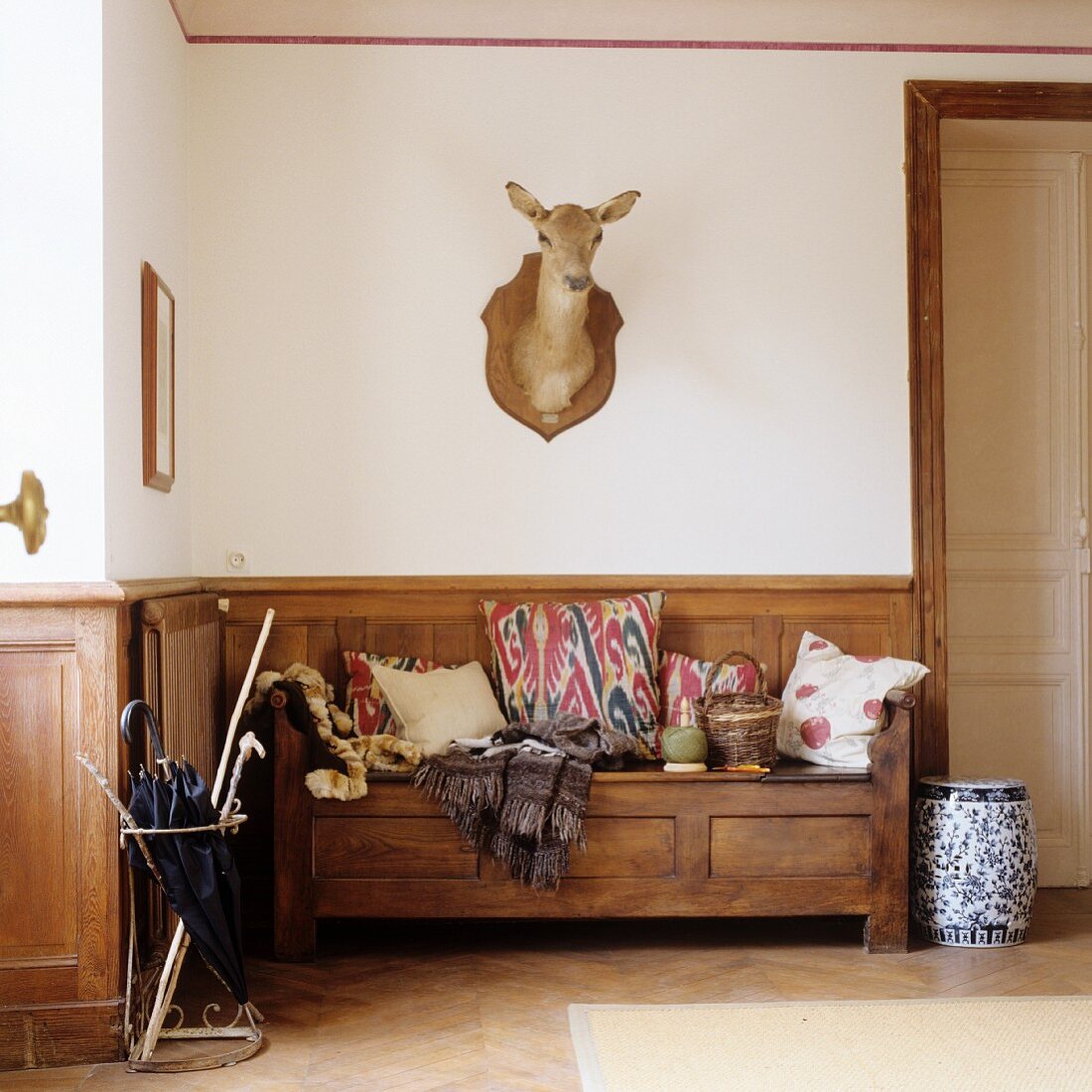 Foyer with rustic wooden bench and hunting trophy on wall