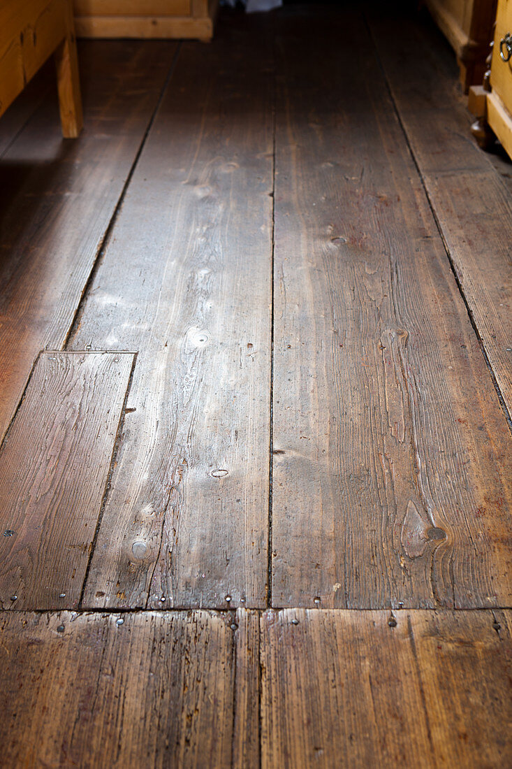 Old floorboards with repaired area