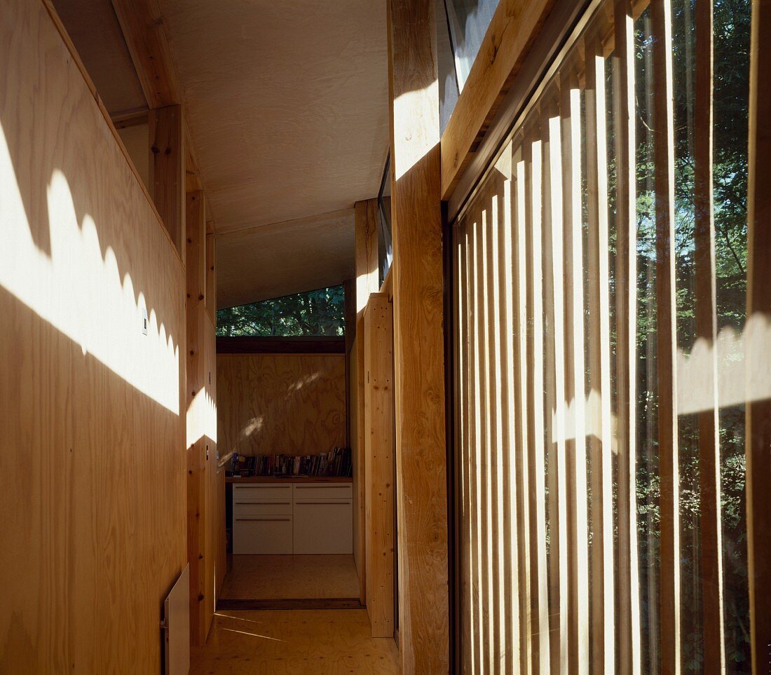 Hall with wood panelling and floor-to-ceiling windows