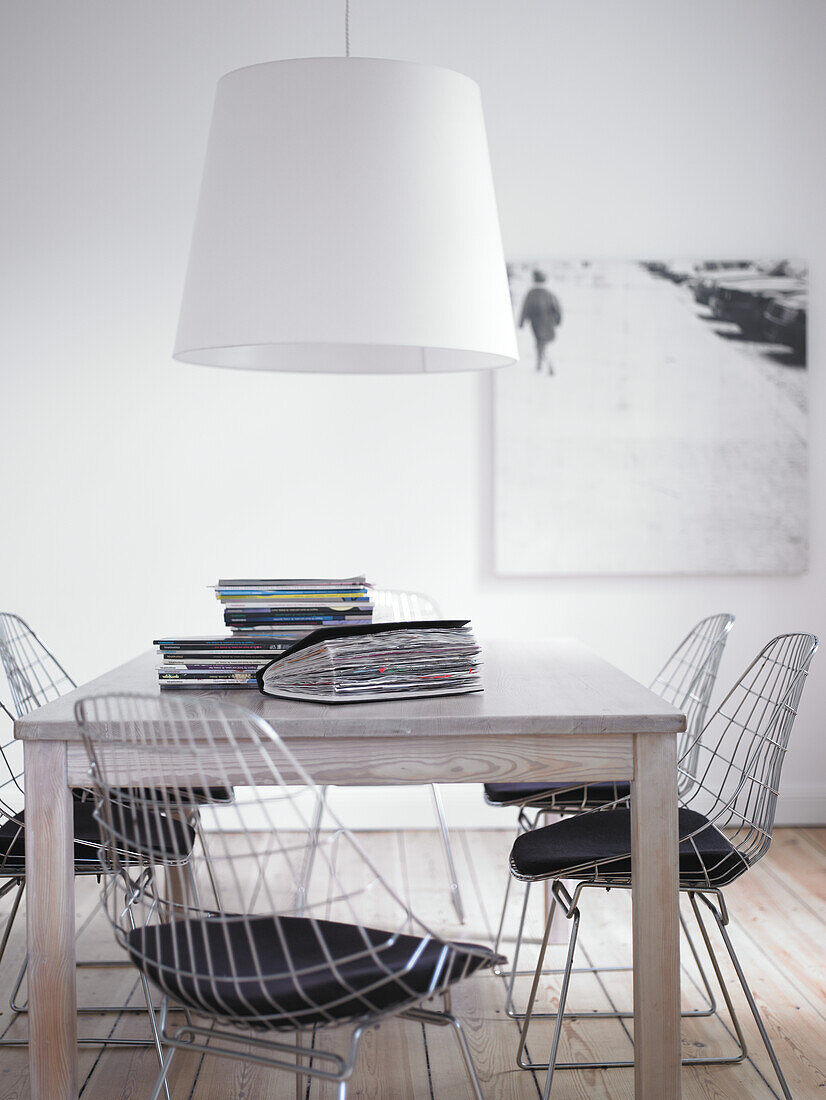 Dining table with wire chairs and pendant light