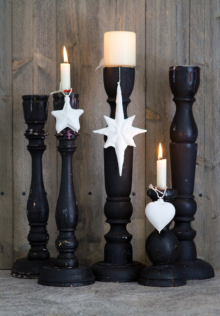 Black candlesticks with white candles and white pendants