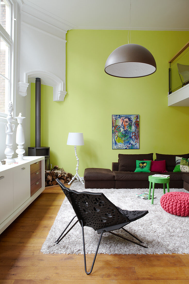 Furniture in a mix of styles and green walls in living room