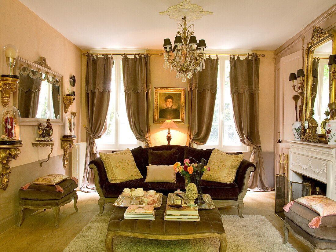 Antique living room with fireplace and chandelier