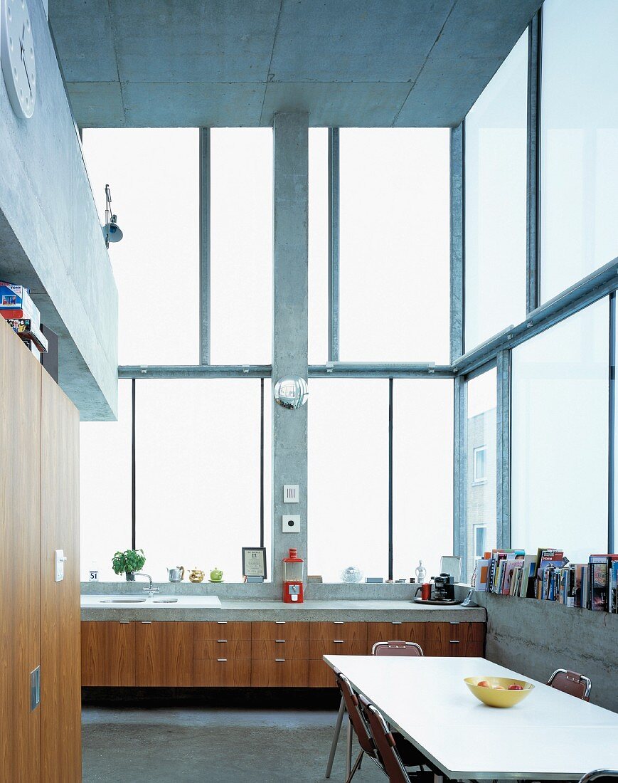 Essplatz in Küche mit Küchenzeile an hoher Fensterfront im zeitgenössischen Wohnhaus