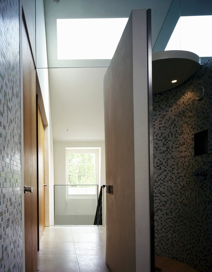 Bathroom with open door and view into stairwell