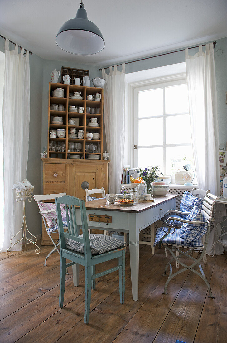 Country-style dining room with wooden furniture and blue and white textiles