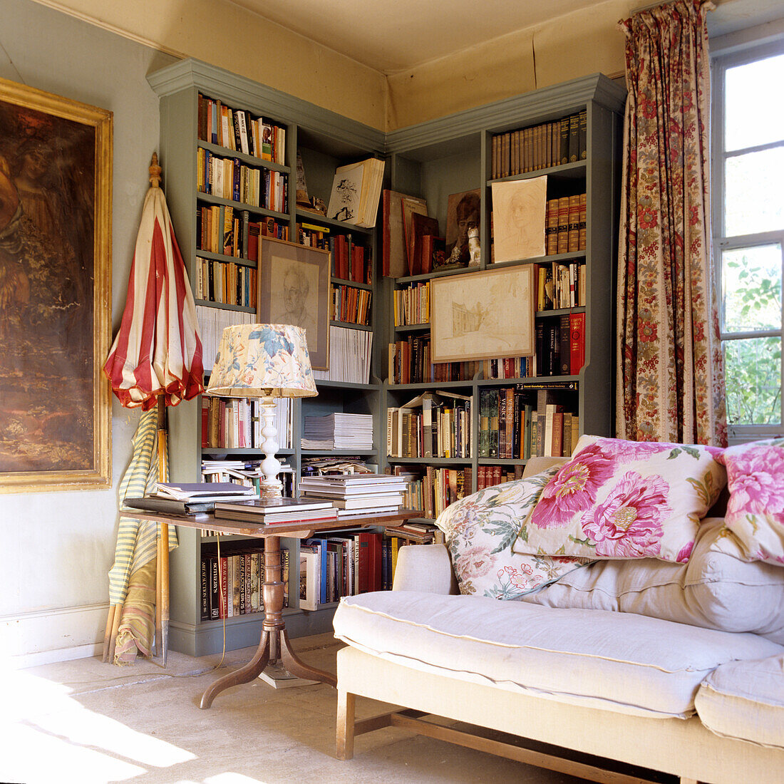 Living room with bookshelves, cozy sofa and classic side table