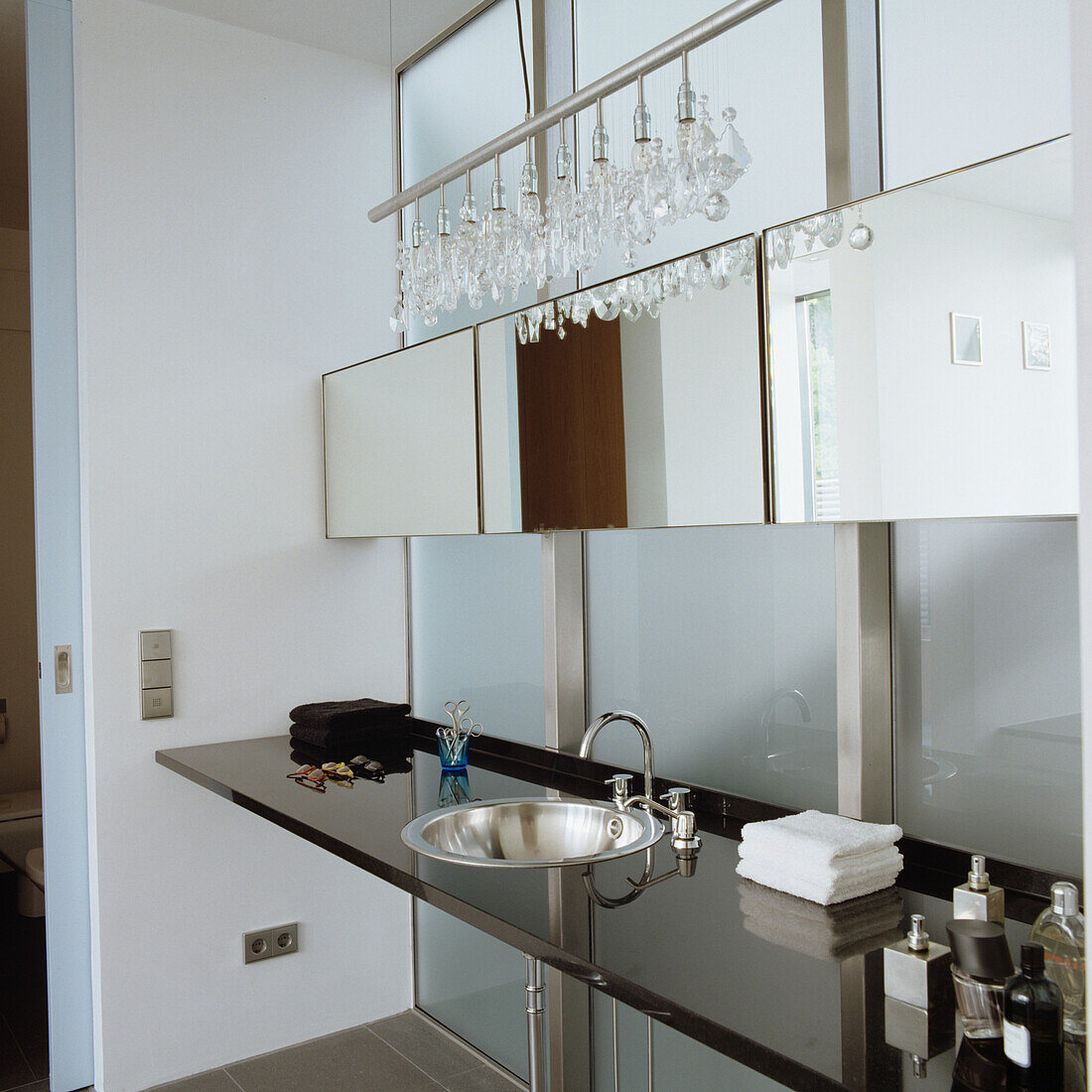 Modern bathroom with crystal light and mirror cabinet