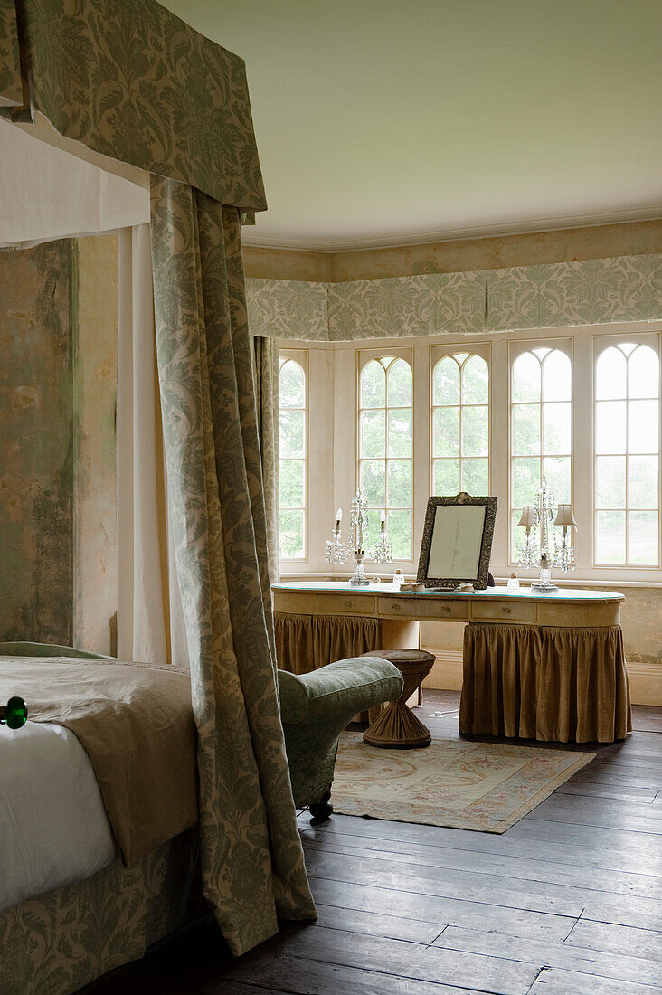 Four-poster bed with matching curtains in a bedroom with a historic ambience