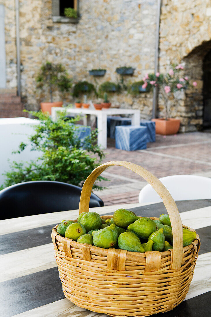 Basket with fresh figs on a table in the Mediterranean courtyard