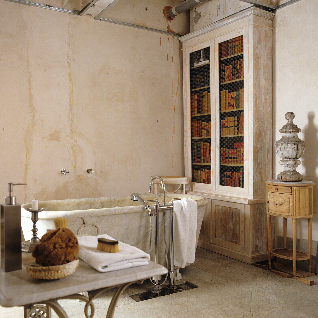 Vintage-Badezimmer mit freistehender Badewanne und Bücherschrank