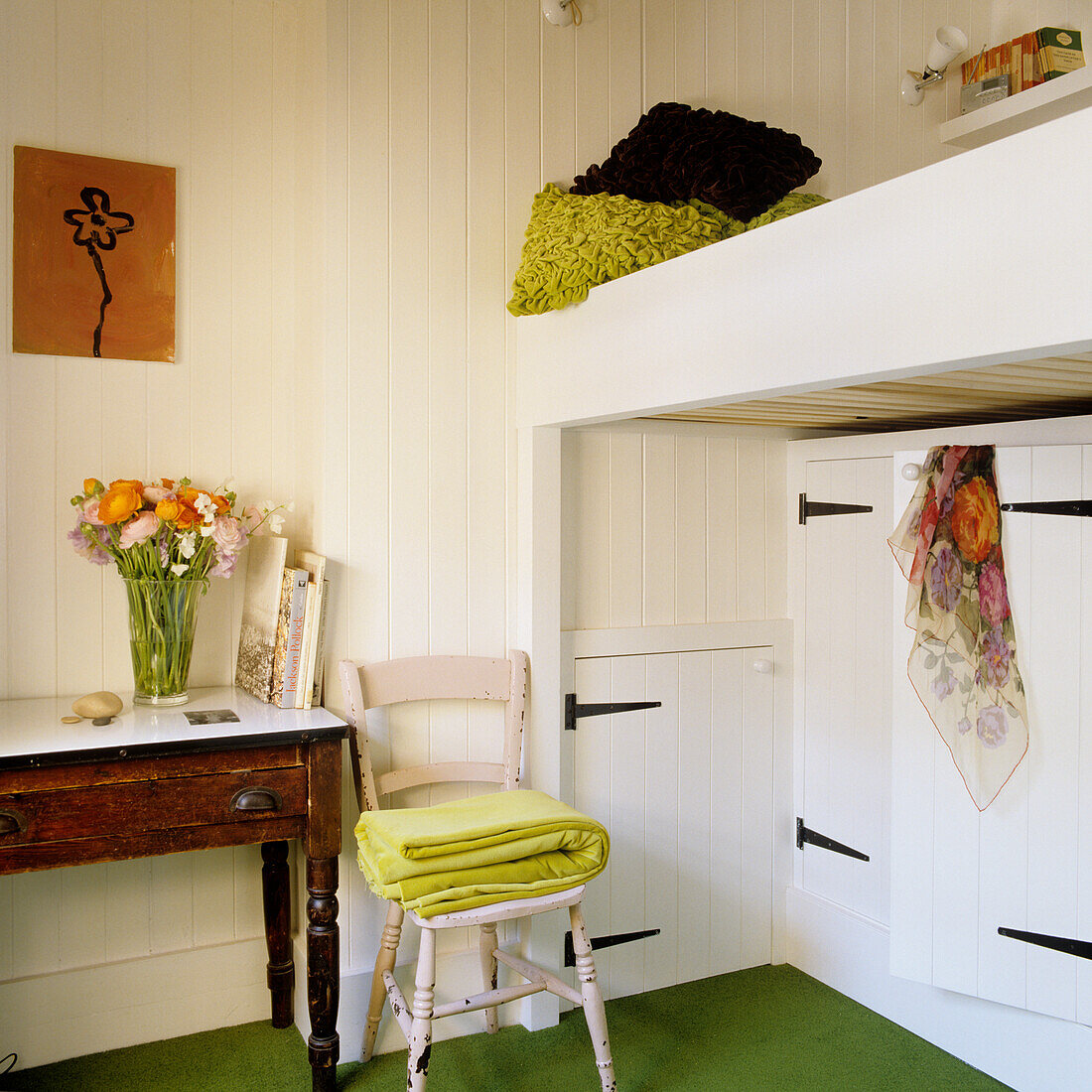 Cosy bedroom with bunk bed and bouquet of flowers on wooden table