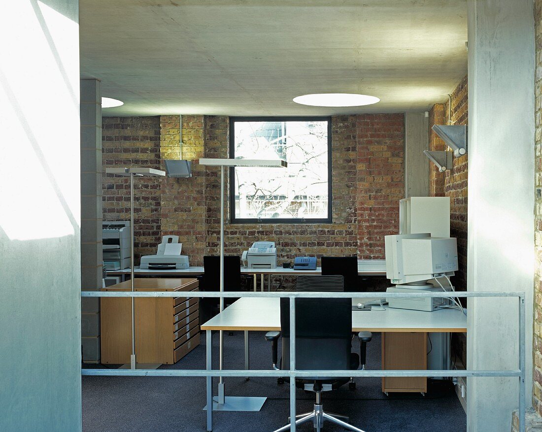 A modern office with a square window and a round skylight