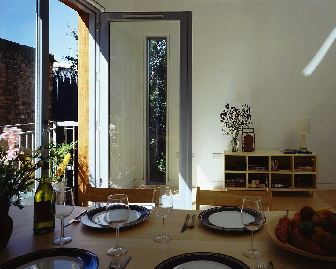 Set table in front of balcony door in plain room