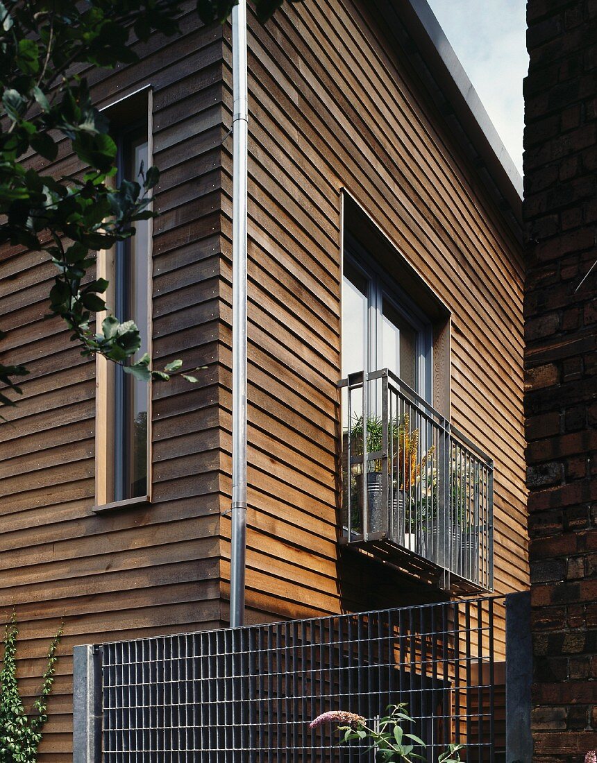 Modernes Holzhaus mit Balkon aus Metall