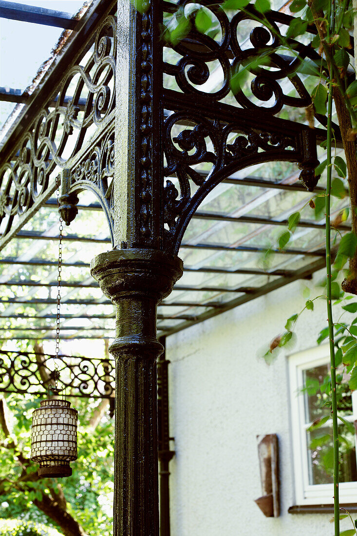 Cast-iron pillar with ornaments and lantern on a covered gazebo