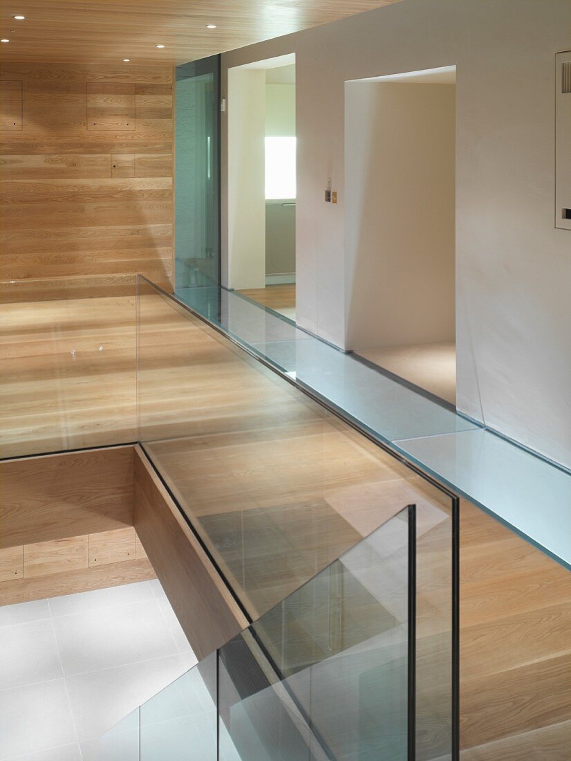 Detail of staircase with glass balustrade in modern hallway