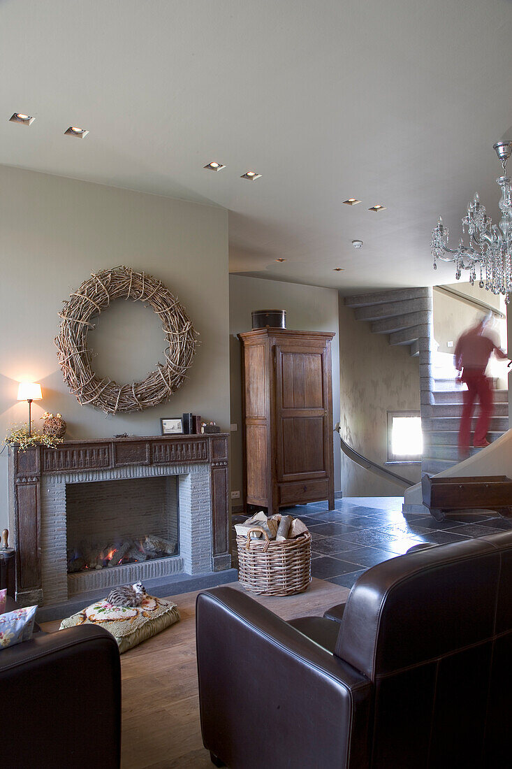 Living room with fireplace, staircase and brown leather furniture