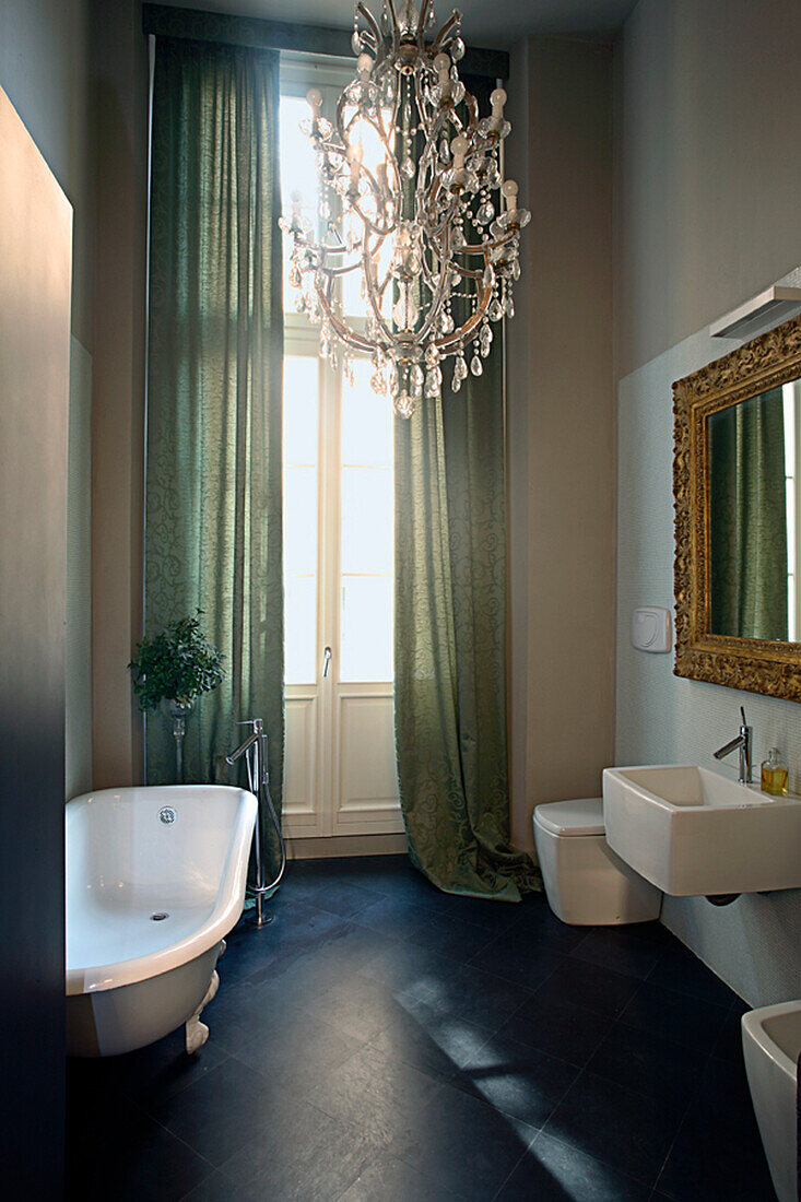 Bathroom with freestanding bathtub and crystal chandelier