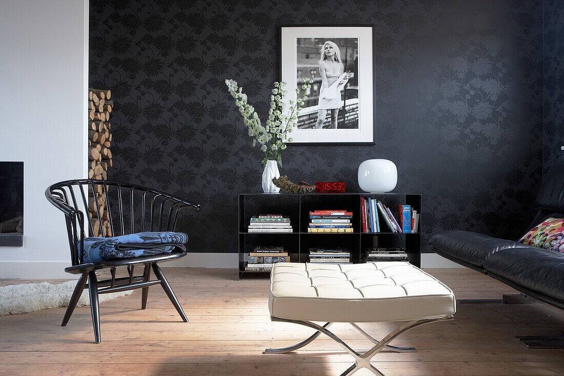 Modern living room with black patterned wallpaper and designer furniture