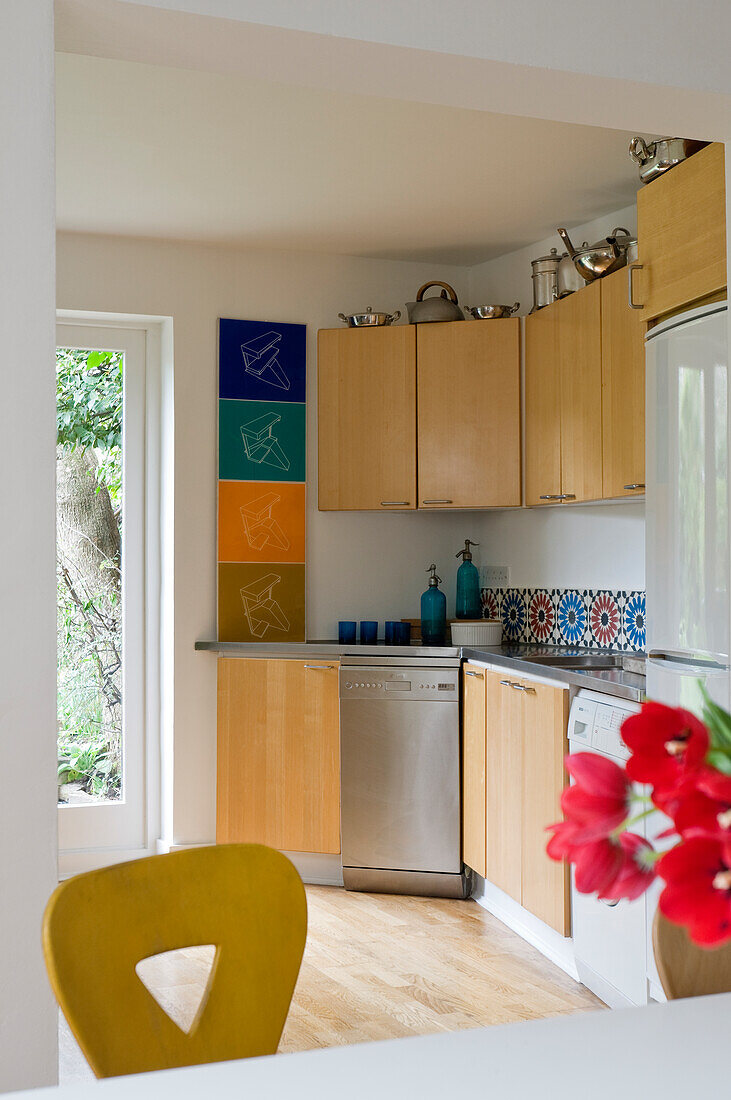 Kitchen unit with wooden cupboards and patterned wall tiles