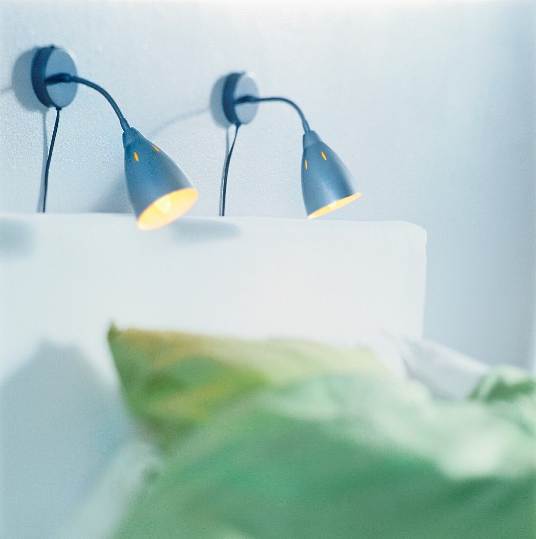 Two reading lamps above bed