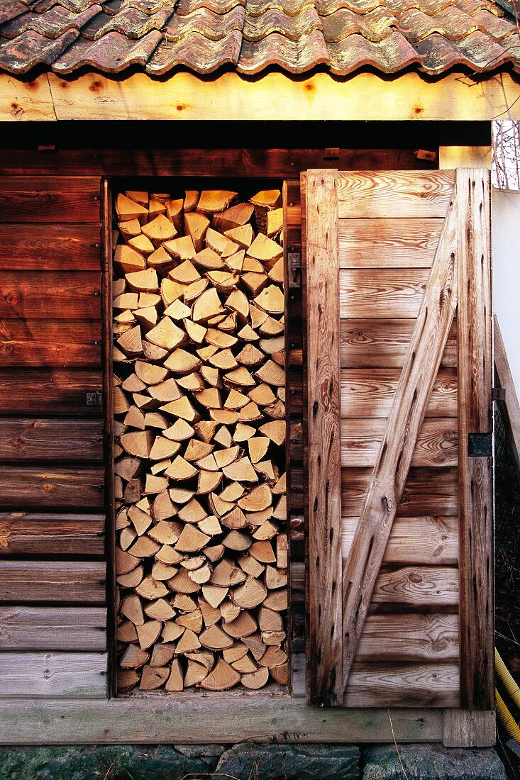Stacked firewood in shed