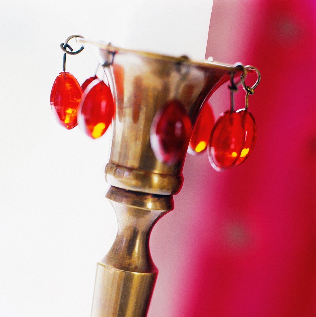 Brass candlestick with red glass beads