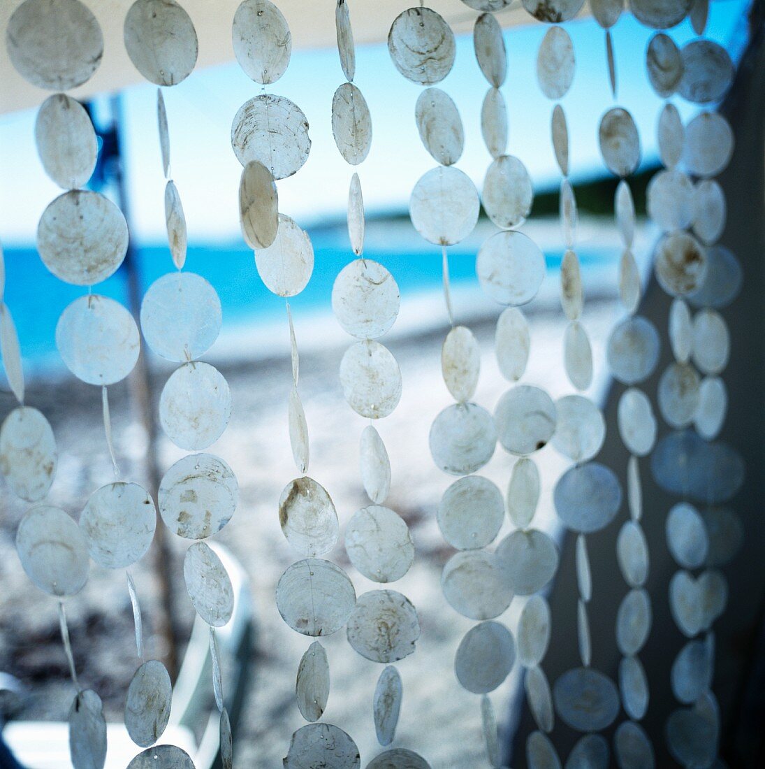 Curtain of discs hanging in a tent at the seaside