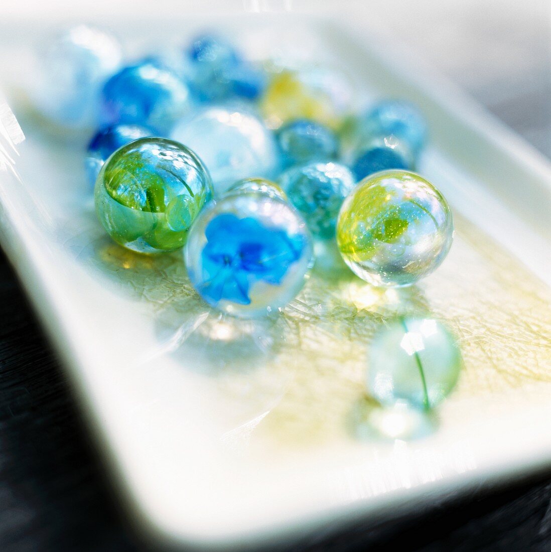 Colourful glass marbles on a tray