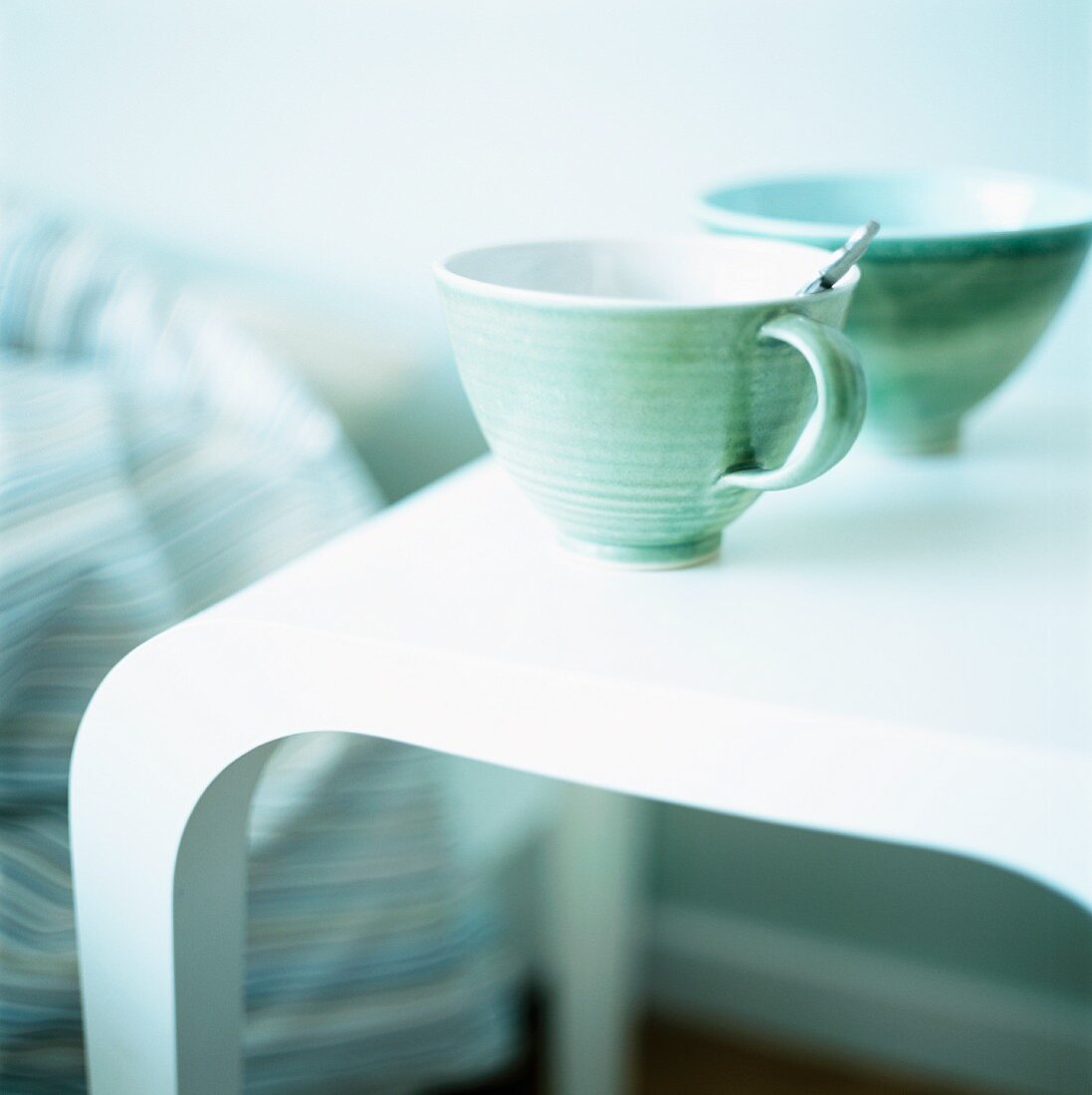 Cup and bowl on side table in bedroom