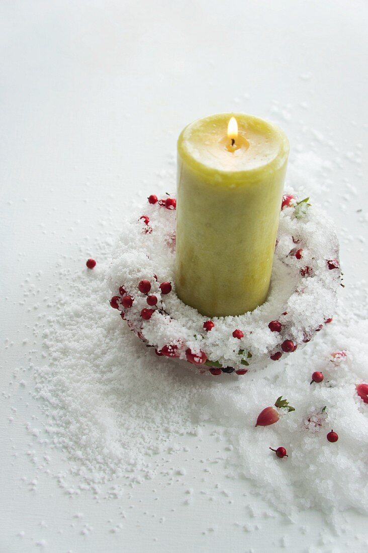Candle holder made of ice & berries with candle