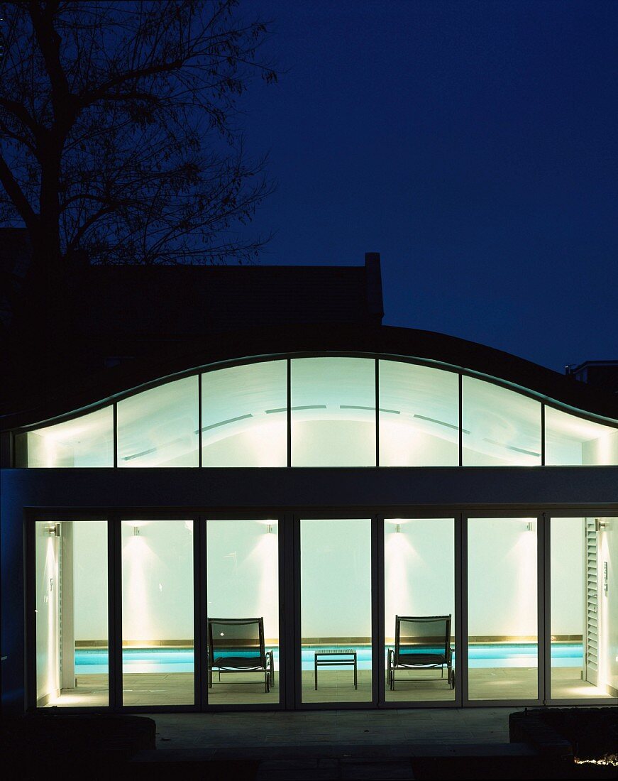 Illuminated pool house from outside