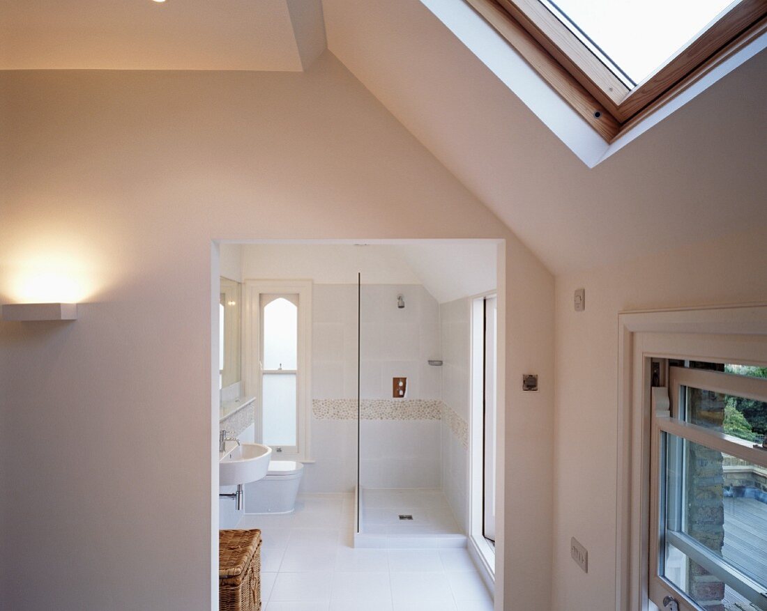 View into white bathroom with shower