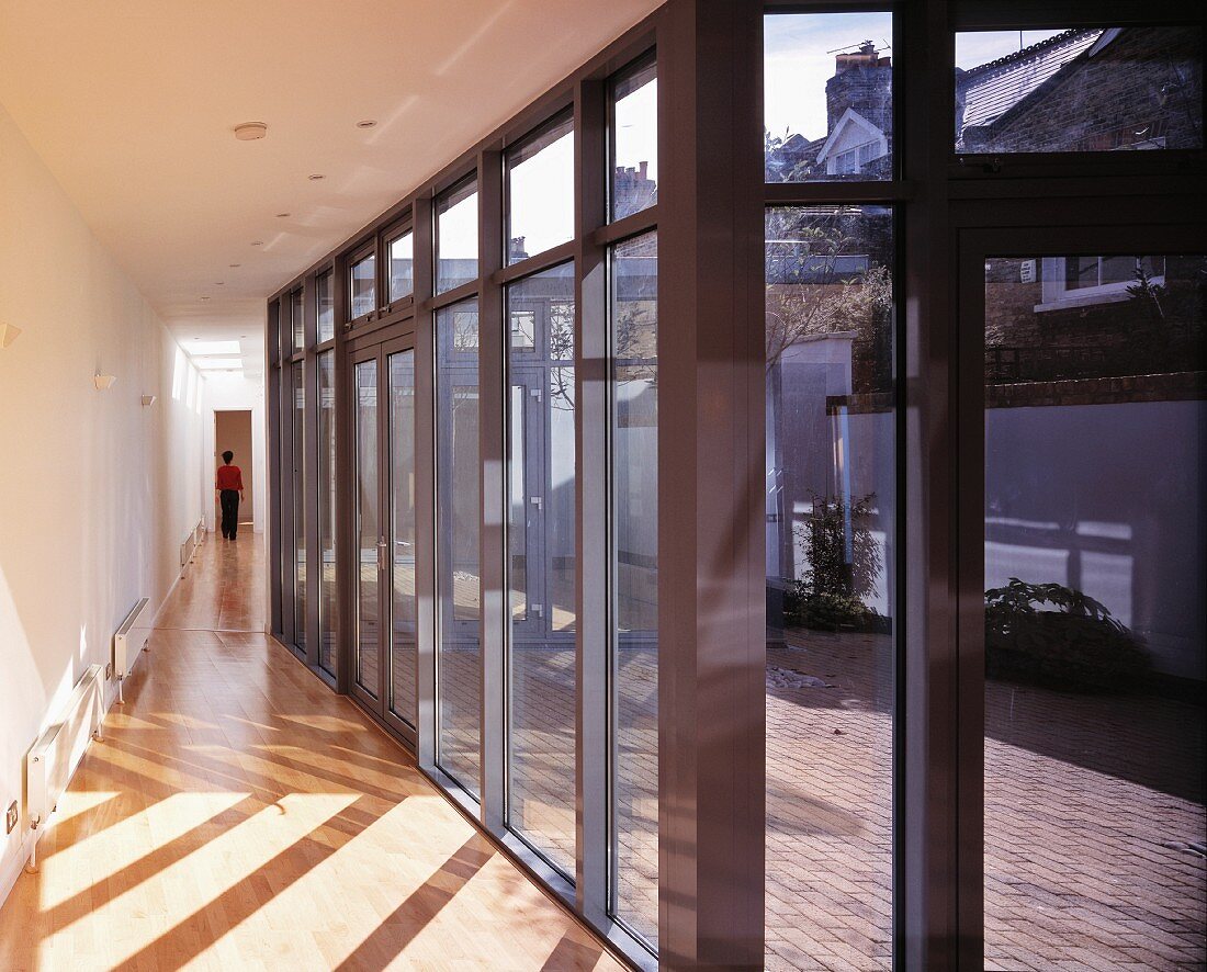 Long corridor with glass wall leading to terrace