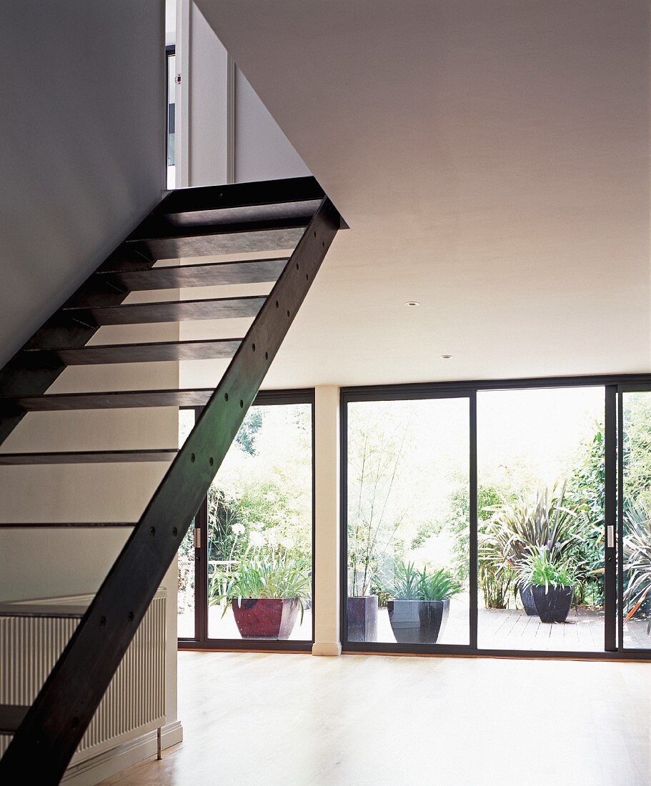 Metal staircase in living room with terrace in background