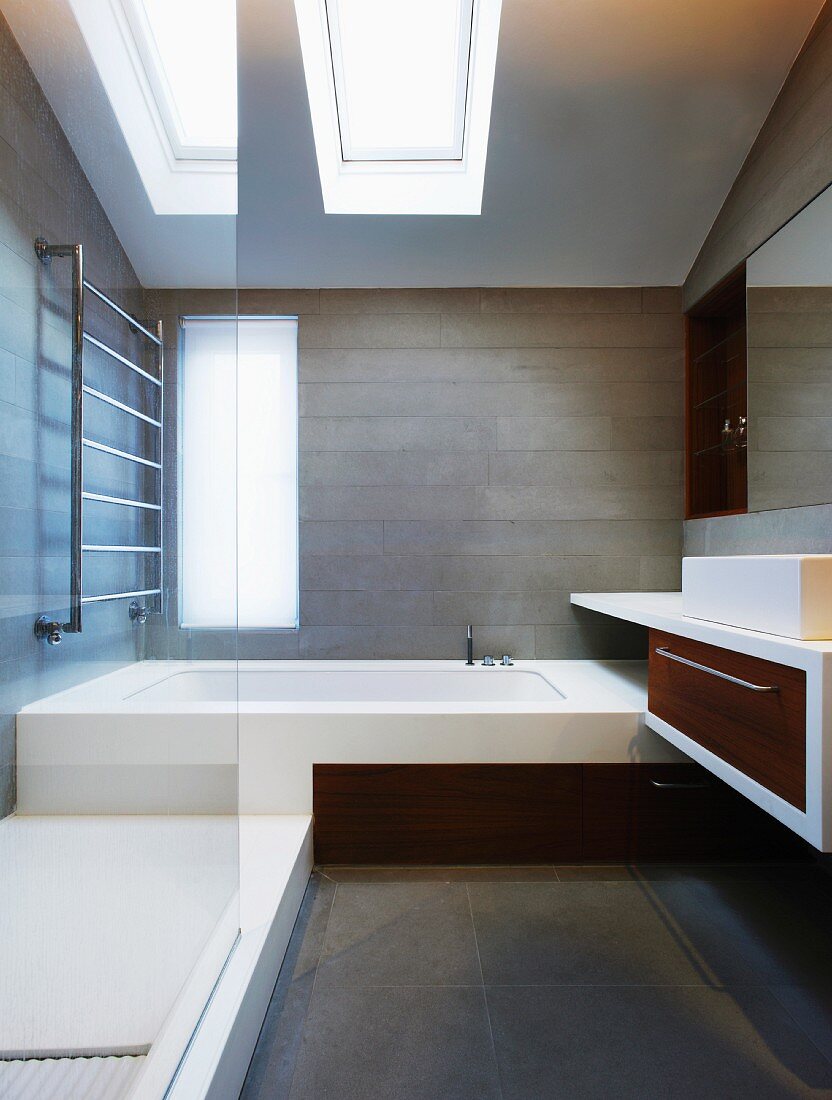 Designer bathroom with skylights and made-to-measure installations in attic storey