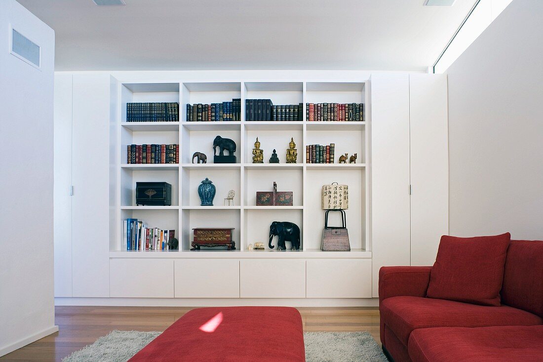 Living room with red sofa set and fitted bookcase