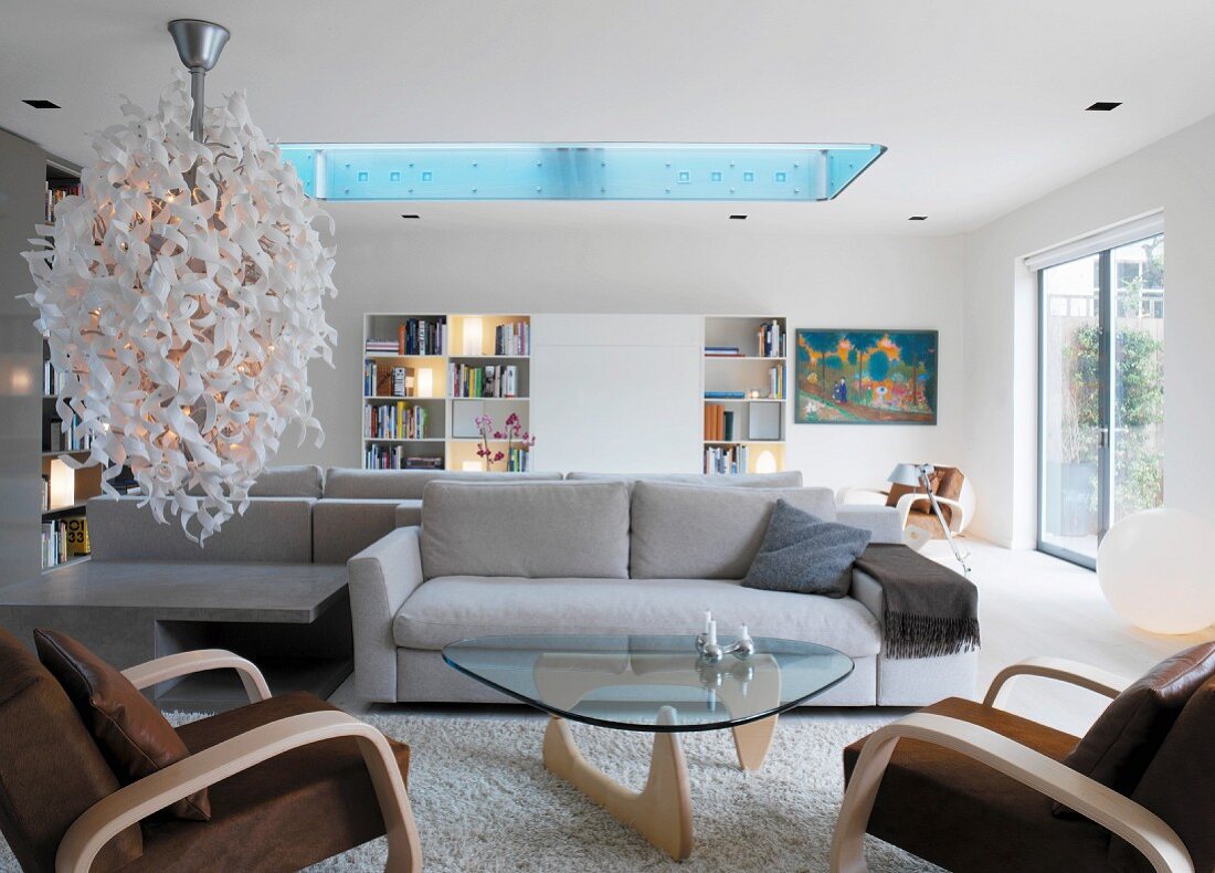 Bright living room with designer lamp and skylight